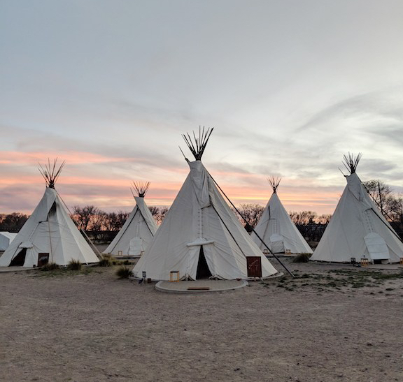 Sunset photograph of tepees at El Cosmico in Marfa, Texas.