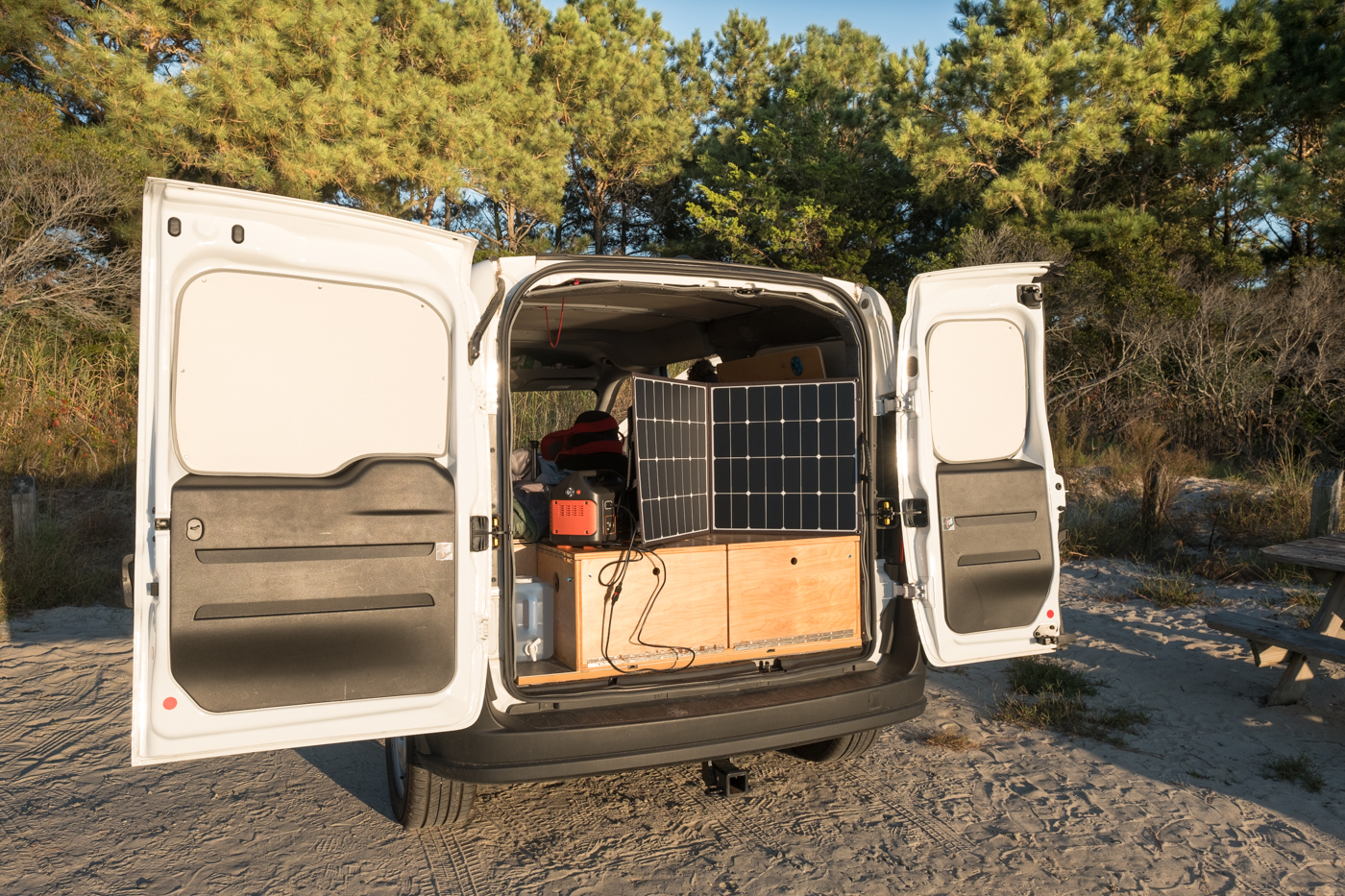 a photo of the backdoors open of a Ram Promaster City van using a Jackery Explorer 500 Portable Power Station and Solar Panel