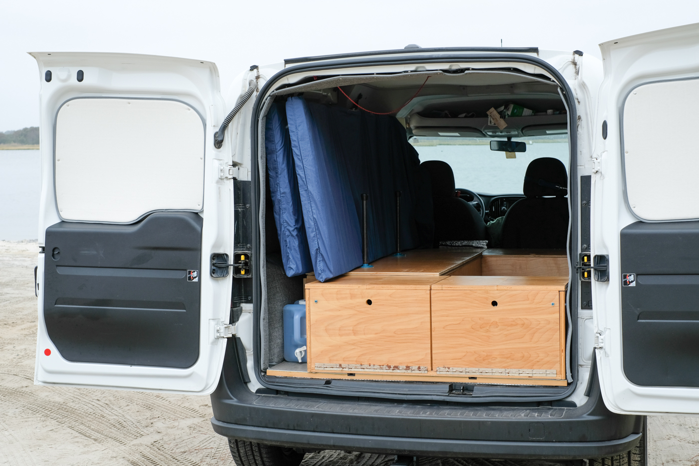 The back of a Ram Promaster City with a Wayfarer Camper Van Conversion Kit and a DIY Bed